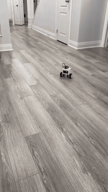The self-balancing robot holding itself upright and driving across a floor.